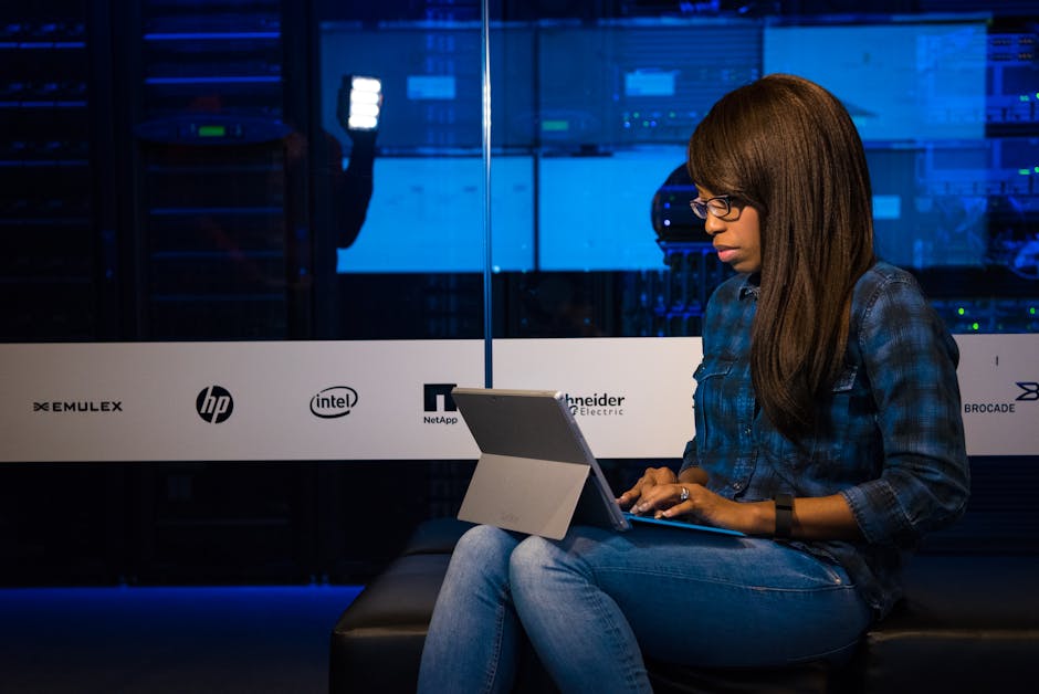 Professional working on tablet in a secure server environment representing modern workplace management